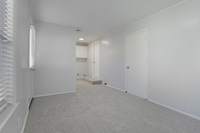 carpeted empty room with ornamental molding