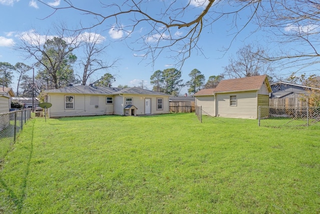 rear view of property featuring a yard