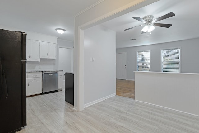 kitchen featuring dishwasher, black refrigerator, light hardwood / wood-style flooring, tasteful backsplash, and white cabinetry