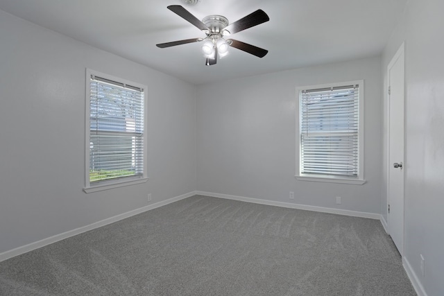 carpeted spare room featuring ceiling fan