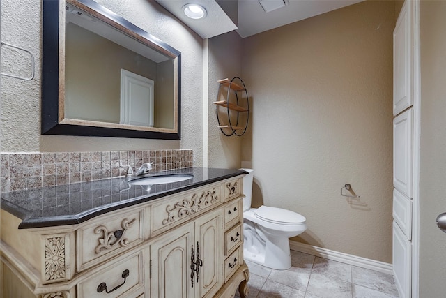 bathroom featuring vanity, tile patterned floors, backsplash, and toilet