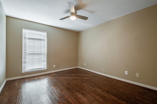 spare room with ceiling fan and dark hardwood / wood-style floors