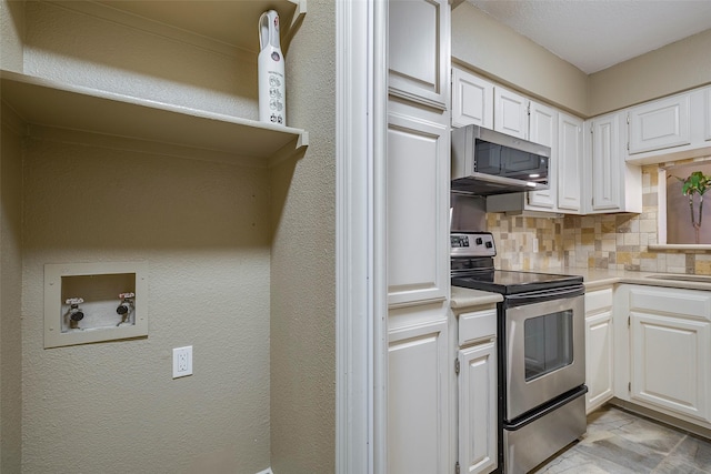 kitchen featuring white cabinetry, stainless steel appliances, and decorative backsplash