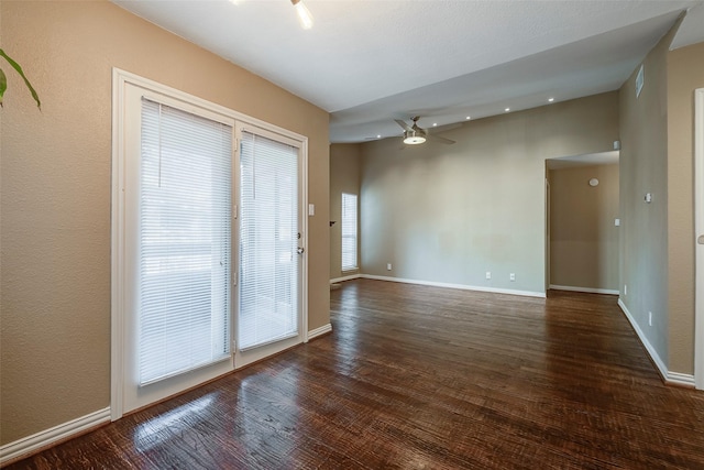 unfurnished room with ceiling fan and dark hardwood / wood-style flooring