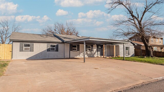 ranch-style house featuring a carport