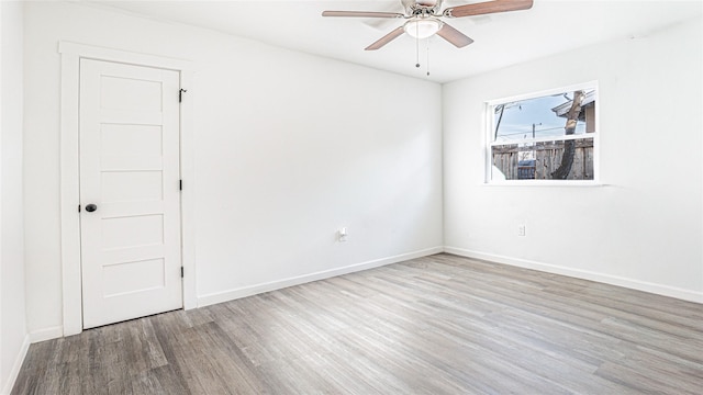 empty room with ceiling fan and hardwood / wood-style floors