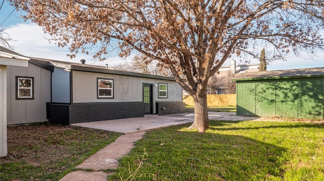 exterior space featuring a front yard and a patio