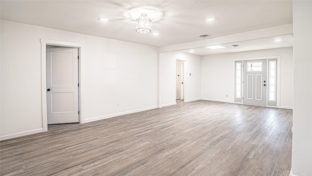 unfurnished room with hardwood / wood-style floors