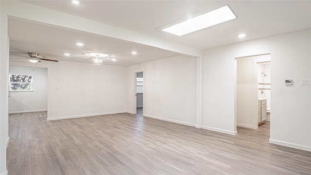 empty room with light hardwood / wood-style flooring and ceiling fan