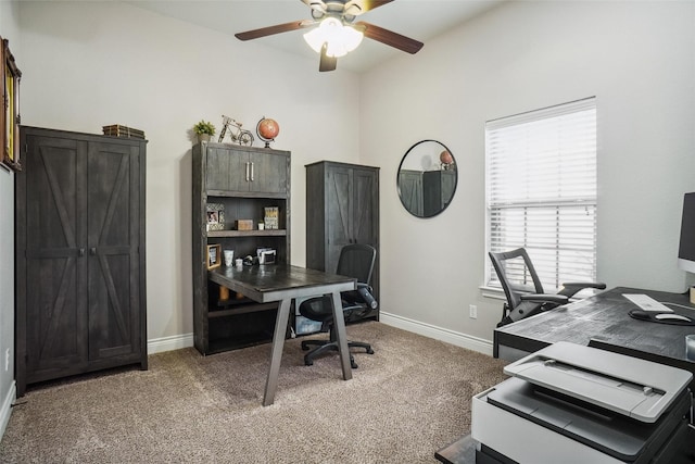 carpeted office featuring ceiling fan