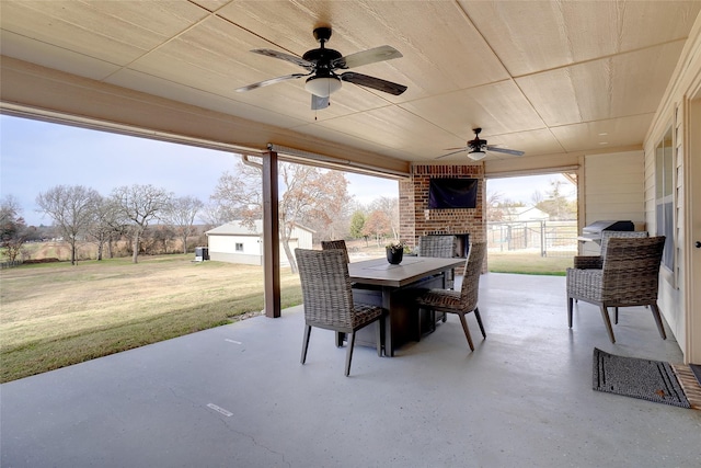 view of patio featuring a grill and an outdoor brick fireplace