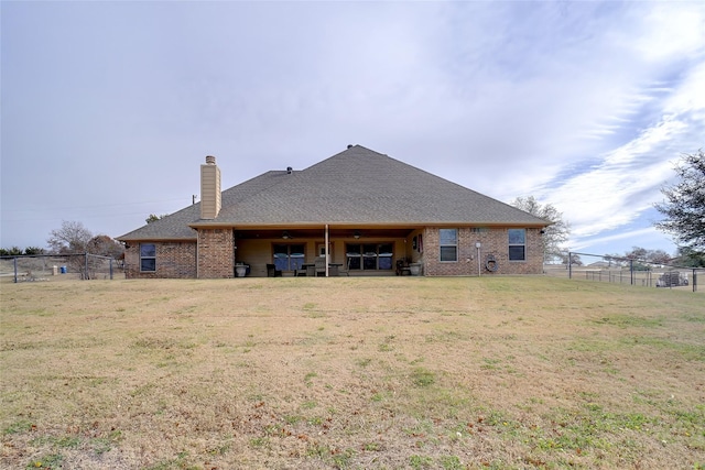 back of house with a yard