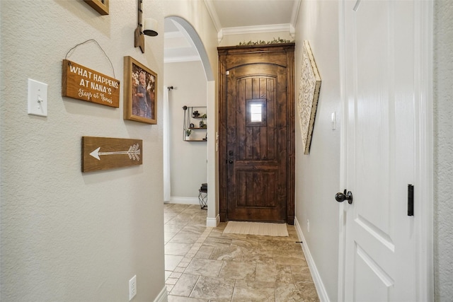 entryway featuring crown molding