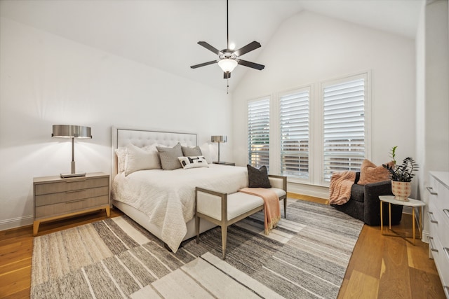 bedroom featuring ceiling fan, wood-type flooring, and vaulted ceiling