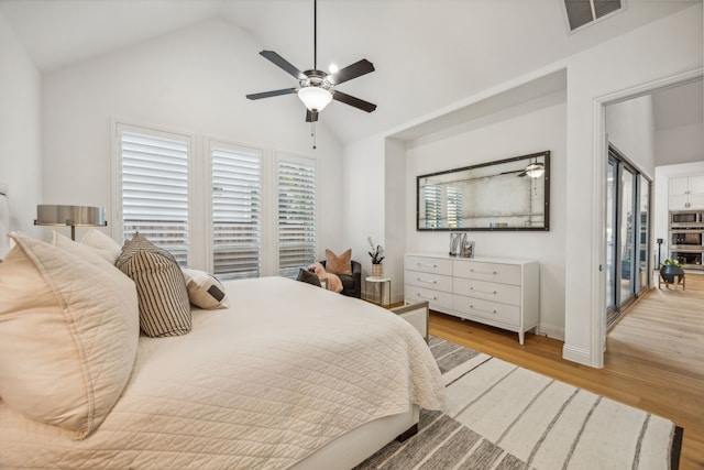 bedroom featuring access to exterior, light wood-type flooring, ceiling fan, and lofted ceiling