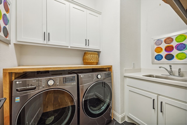 clothes washing area featuring cabinets, independent washer and dryer, and sink