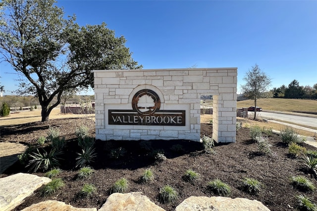 community sign with a rural view