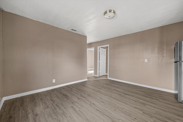 empty room with hardwood / wood-style floors