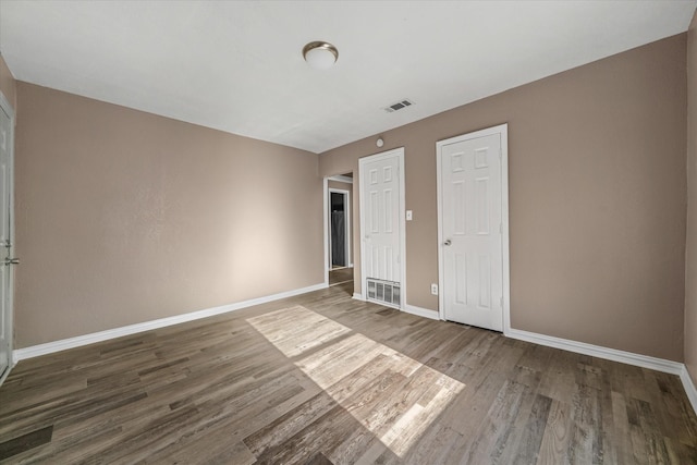 unfurnished bedroom featuring wood-type flooring