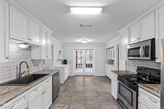 kitchen with appliances with stainless steel finishes, white cabinetry, and sink