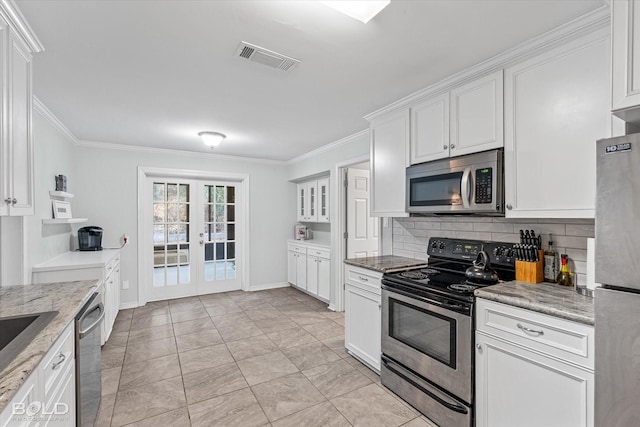 kitchen with french doors, white cabinets, crown molding, light stone counters, and stainless steel appliances