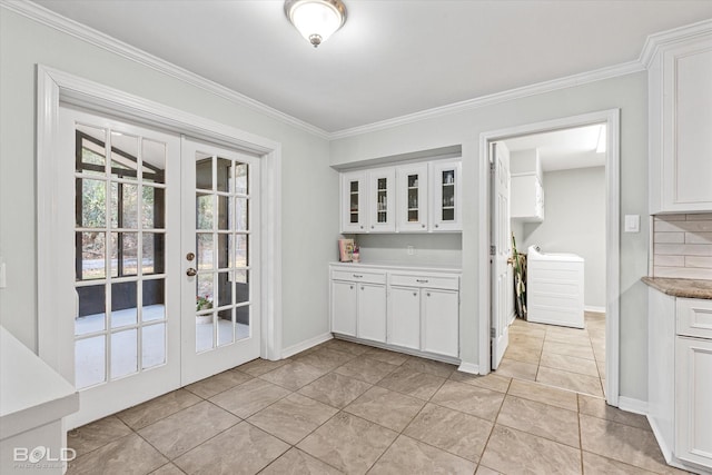 interior space featuring crown molding, white cabinets, and light tile patterned floors