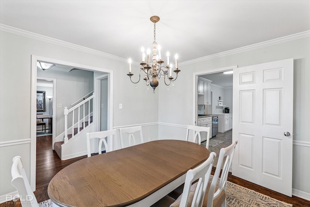 dining room with dark hardwood / wood-style floors, an inviting chandelier, and crown molding