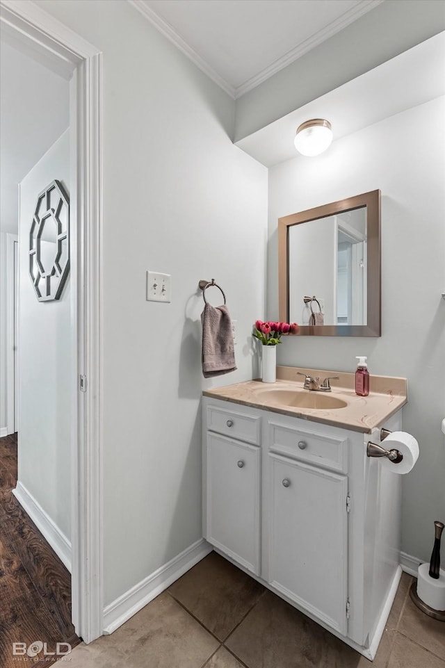 bathroom featuring tile patterned flooring, vanity, and ornamental molding