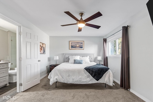 bedroom with light colored carpet, ensuite bath, and ceiling fan