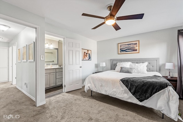 bedroom with connected bathroom, light colored carpet, ceiling fan, and sink