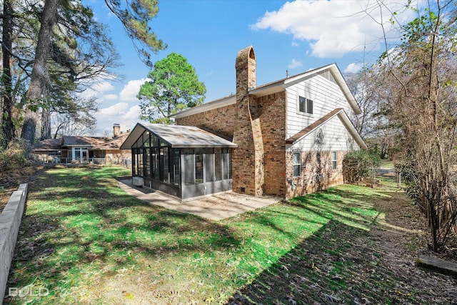 back of house with a sunroom, a yard, and a patio