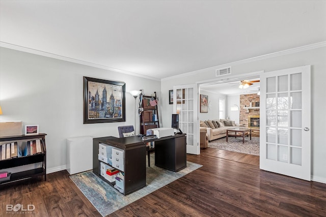 office area with a brick fireplace, dark hardwood / wood-style floors, ornamental molding, and french doors