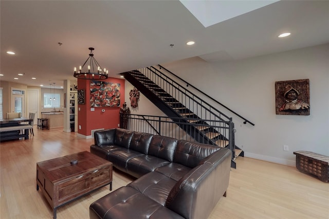 living room with a notable chandelier and light wood-type flooring