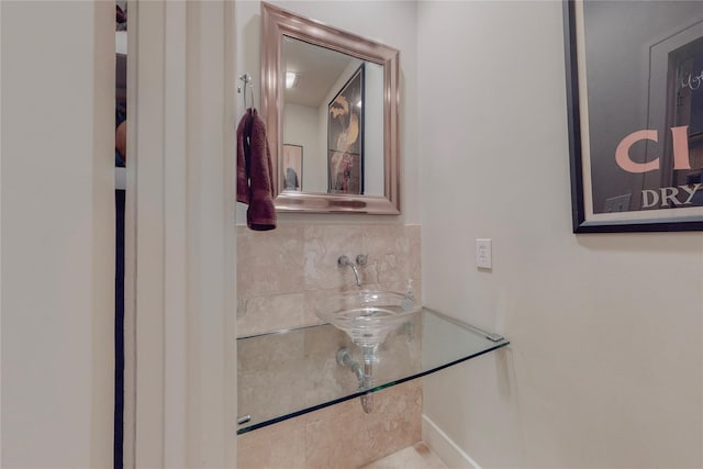 bathroom with tasteful backsplash and sink