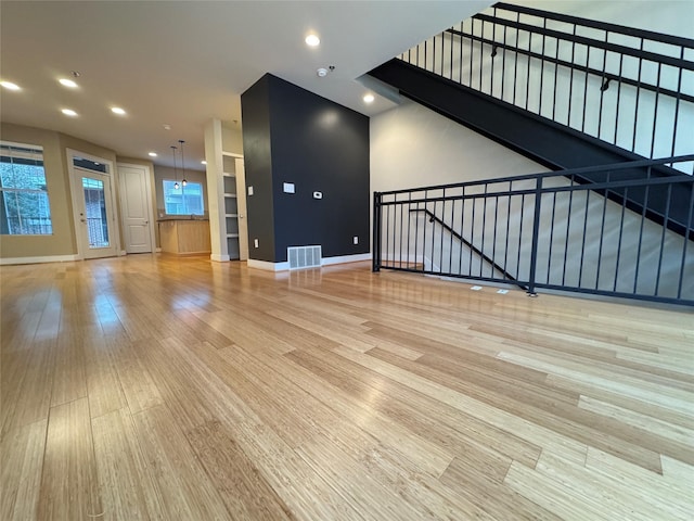 unfurnished living room featuring light hardwood / wood-style flooring