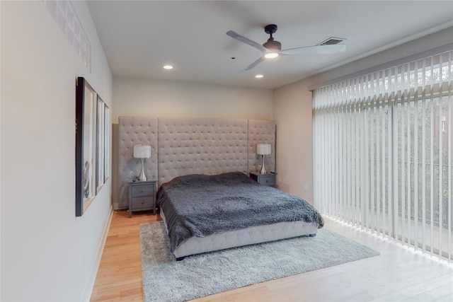 bedroom featuring access to exterior, hardwood / wood-style flooring, and ceiling fan