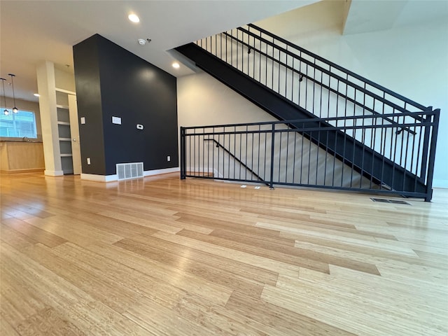 unfurnished living room with wood-type flooring