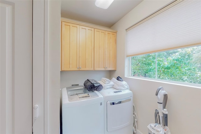 laundry room with cabinets and washing machine and dryer