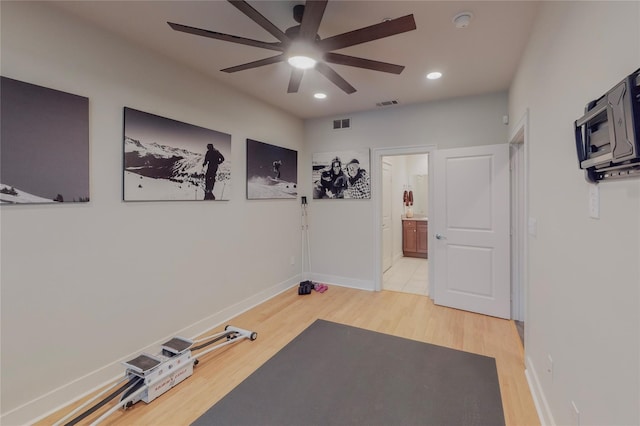 exercise room featuring ceiling fan and wood-type flooring