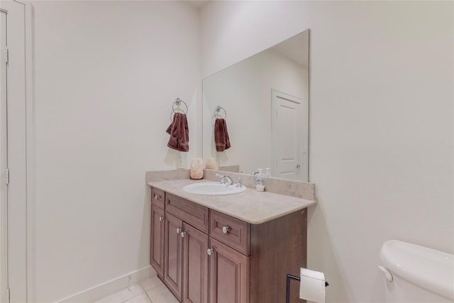 bathroom with tile patterned flooring, vanity, and toilet