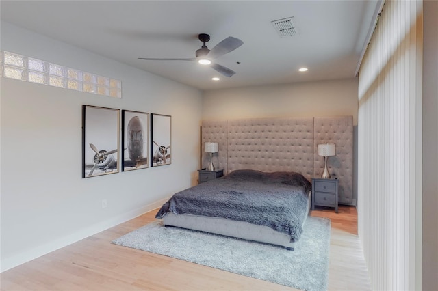 bedroom with ceiling fan and hardwood / wood-style floors