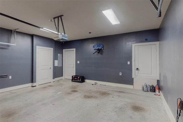 garage with electric panel and a garage door opener