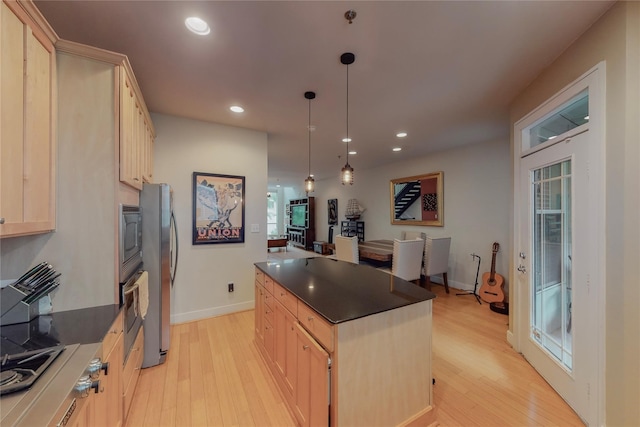 kitchen with a center island, light brown cabinets, hanging light fixtures, light hardwood / wood-style flooring, and stainless steel appliances