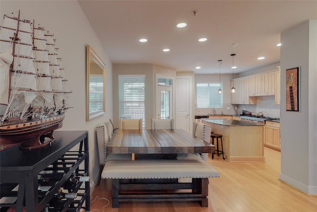 dining space featuring sink and light hardwood / wood-style flooring