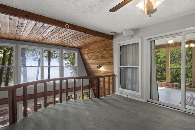 interior space with ceiling fan, wood ceiling, and vaulted ceiling