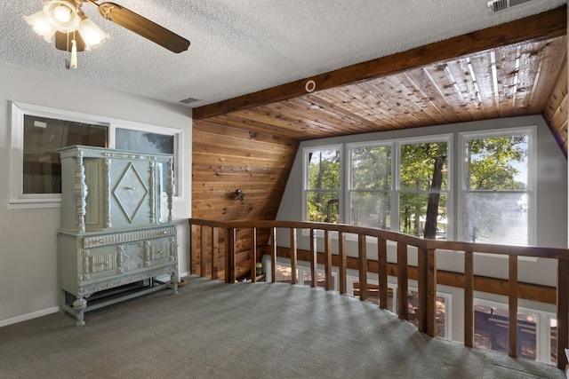 additional living space with plenty of natural light, ceiling fan, wood ceiling, and lofted ceiling with beams