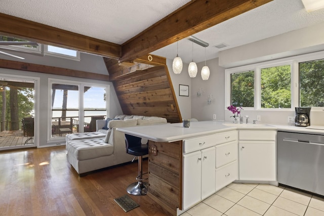 kitchen featuring white cabinets, a textured ceiling, sink, pendant lighting, and dishwasher