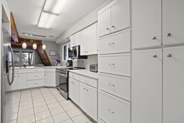 kitchen featuring stainless steel appliances, light tile patterned floors, pendant lighting, a textured ceiling, and white cabinets