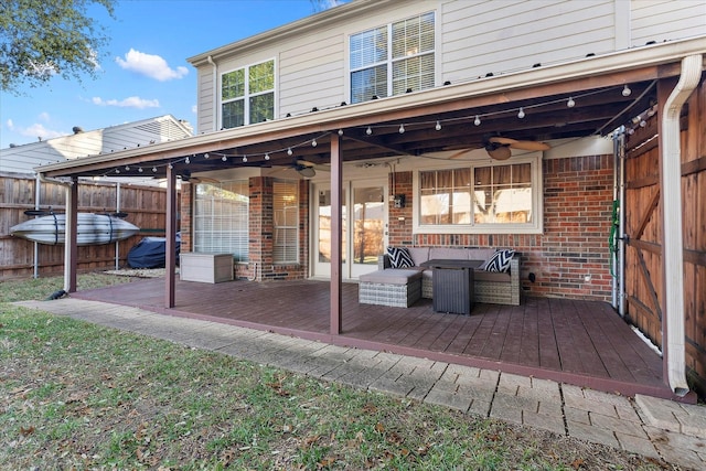 back of property with ceiling fan and a wooden deck