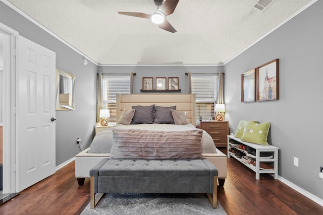 bedroom featuring ceiling fan, ornamental molding, dark hardwood / wood-style flooring, and a textured ceiling